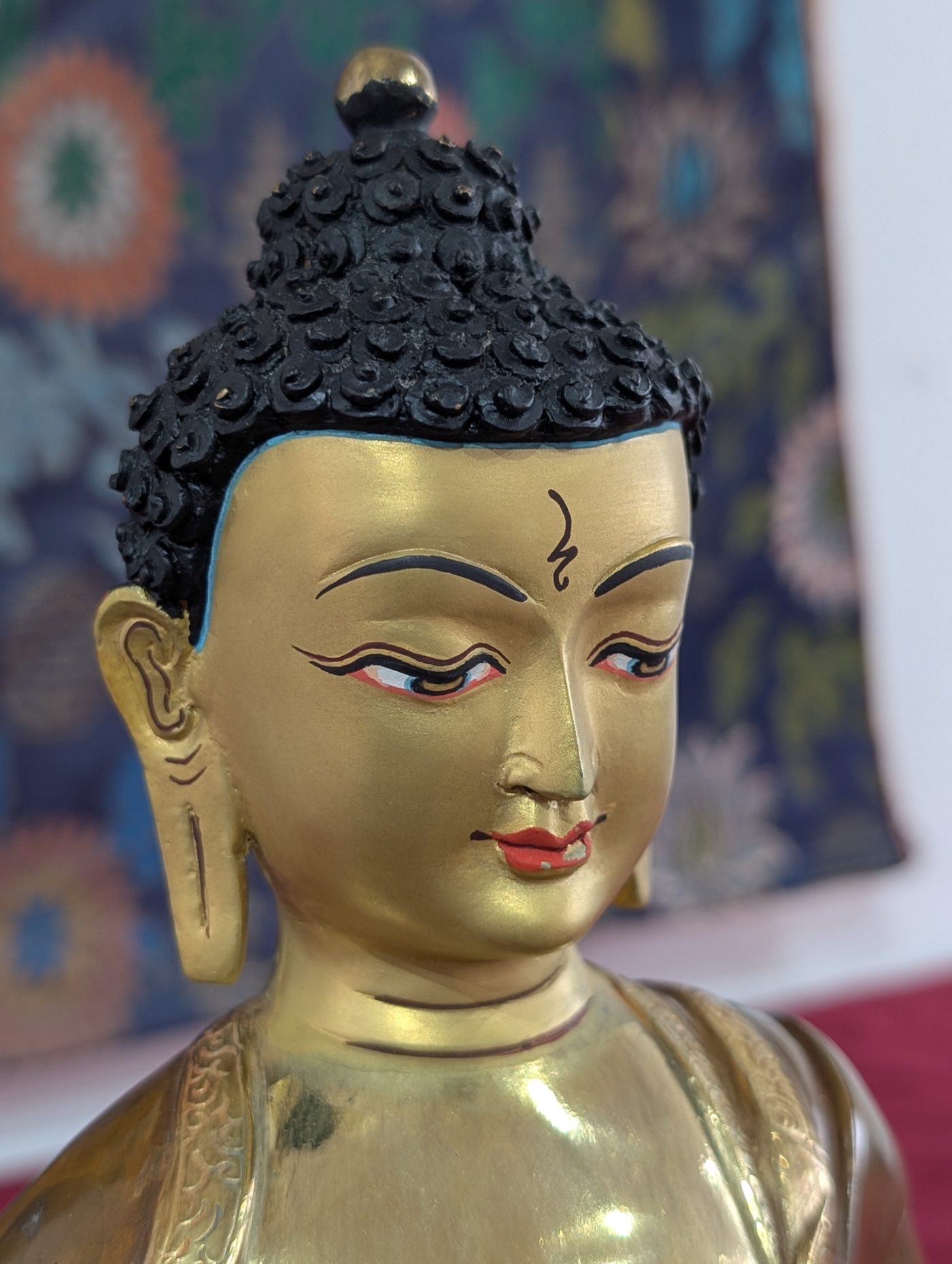Gilded Buddha statue on the shrine at Vajra Moon